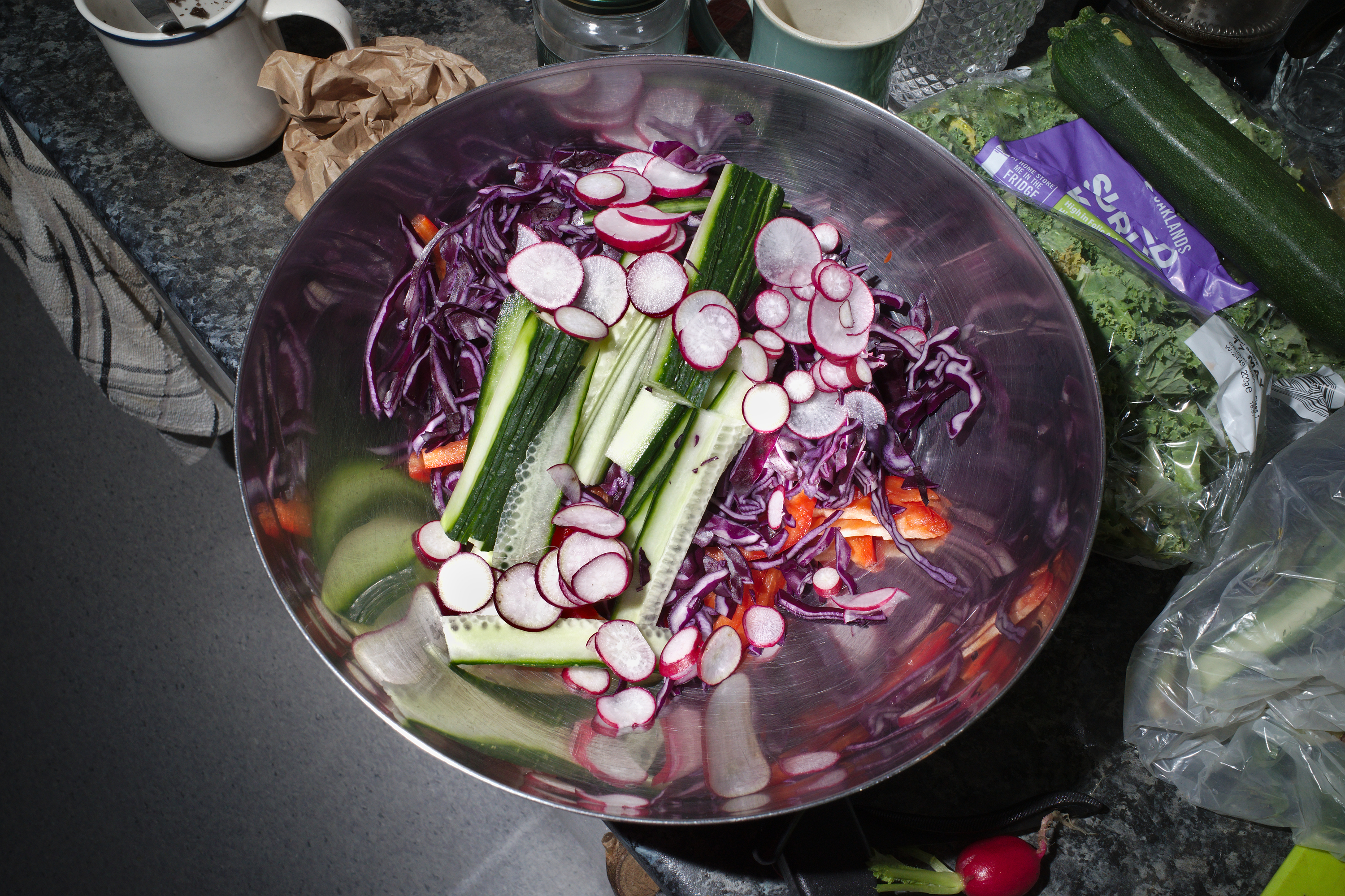 A salad in a metal bowl.